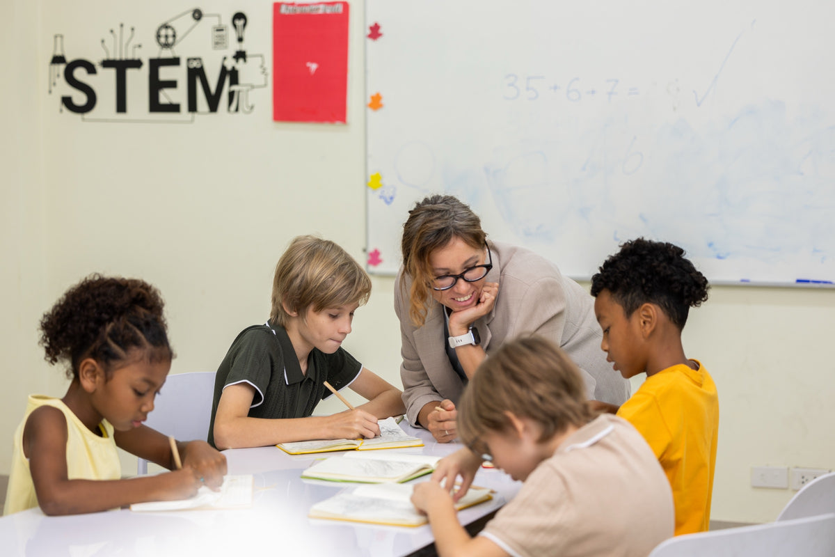 An instructor teaching a small hands-on class at Hexagon Academy